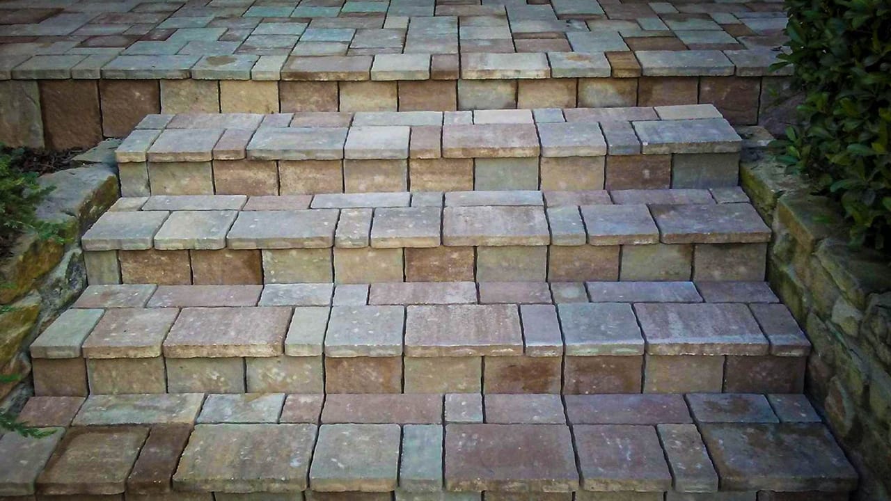 Paver-steps-and-entry-path Frisco home with professionally installed paver patio and seating area