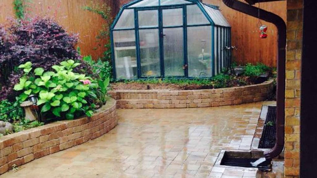 Patio and Wood Deck Services in Lewisville, TX 1 Finished courtyard patio beside a curved garden wall