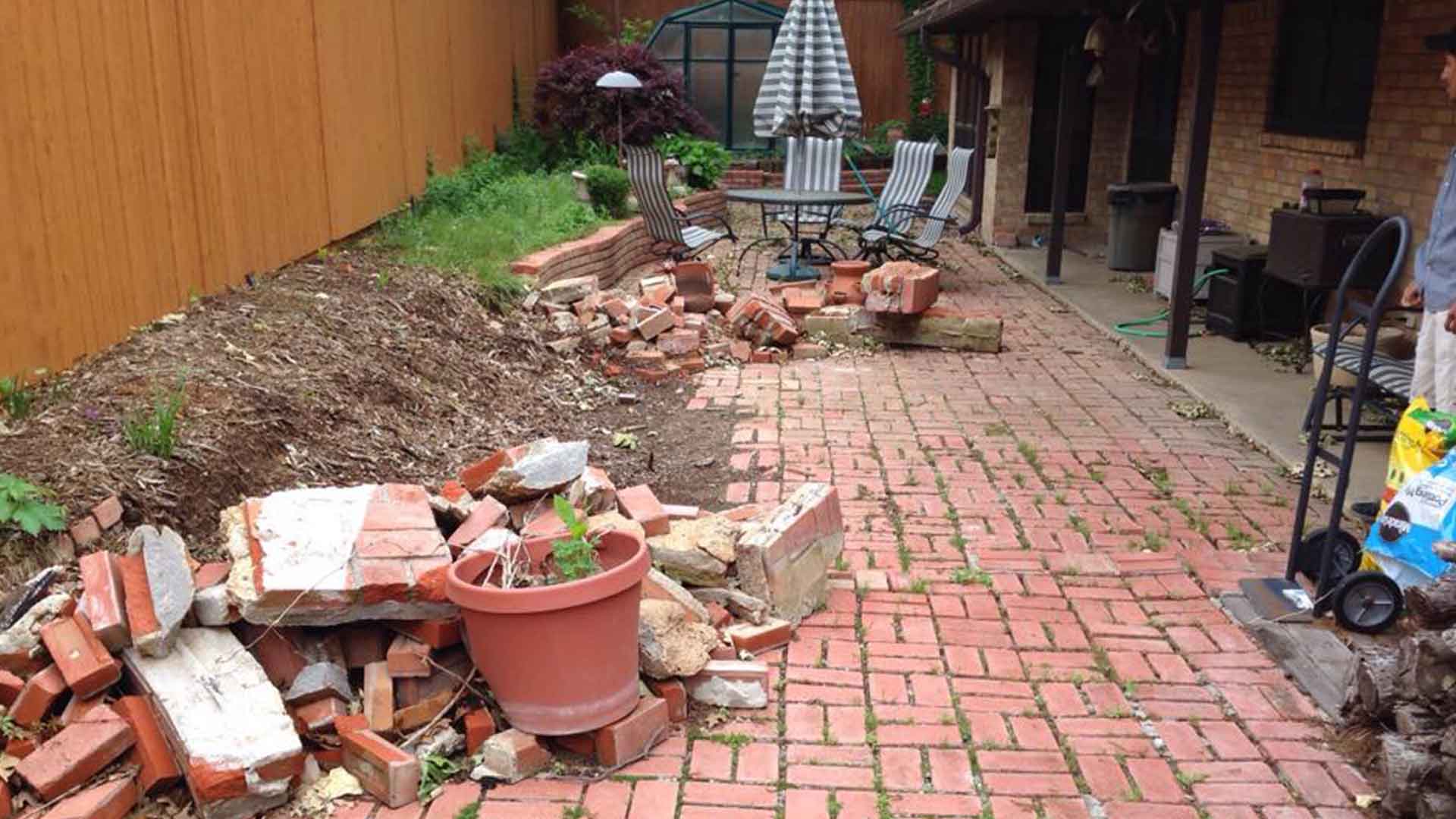 A Courtyard, Reconsidered: Paver Patio Project 1 Aging brick courtyard with disturbed masonry and planting edge before renovation